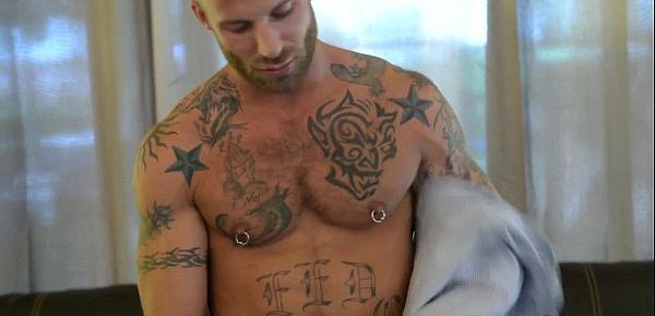  Tattooed gay hunk posing while tugging